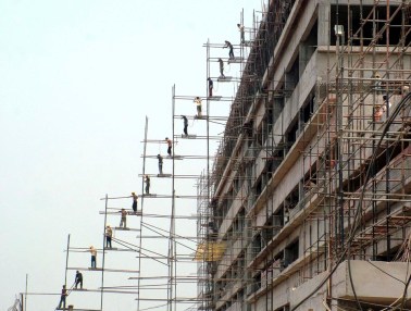 Labourers work at the construction site of a commercial complex in Bhubaneswar